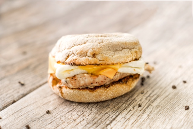Egg white grill with egg whites, grilled chicken, and American cheese on a toasted English Muffin